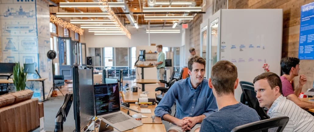 Start-up employees using Submit.com’s accelerator management software in the office