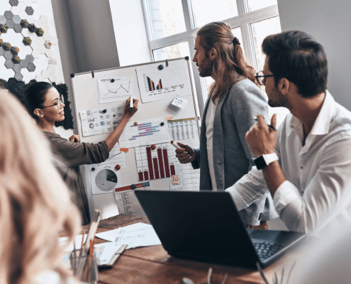 Employees discussing open vs. closed innovation in the office.
